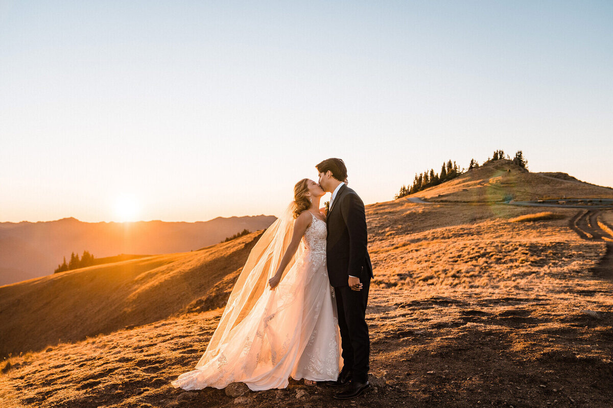 A bride and groom kiss at sunset on a hike on top of Hurricane Ridge after their Olympic National Park elopement