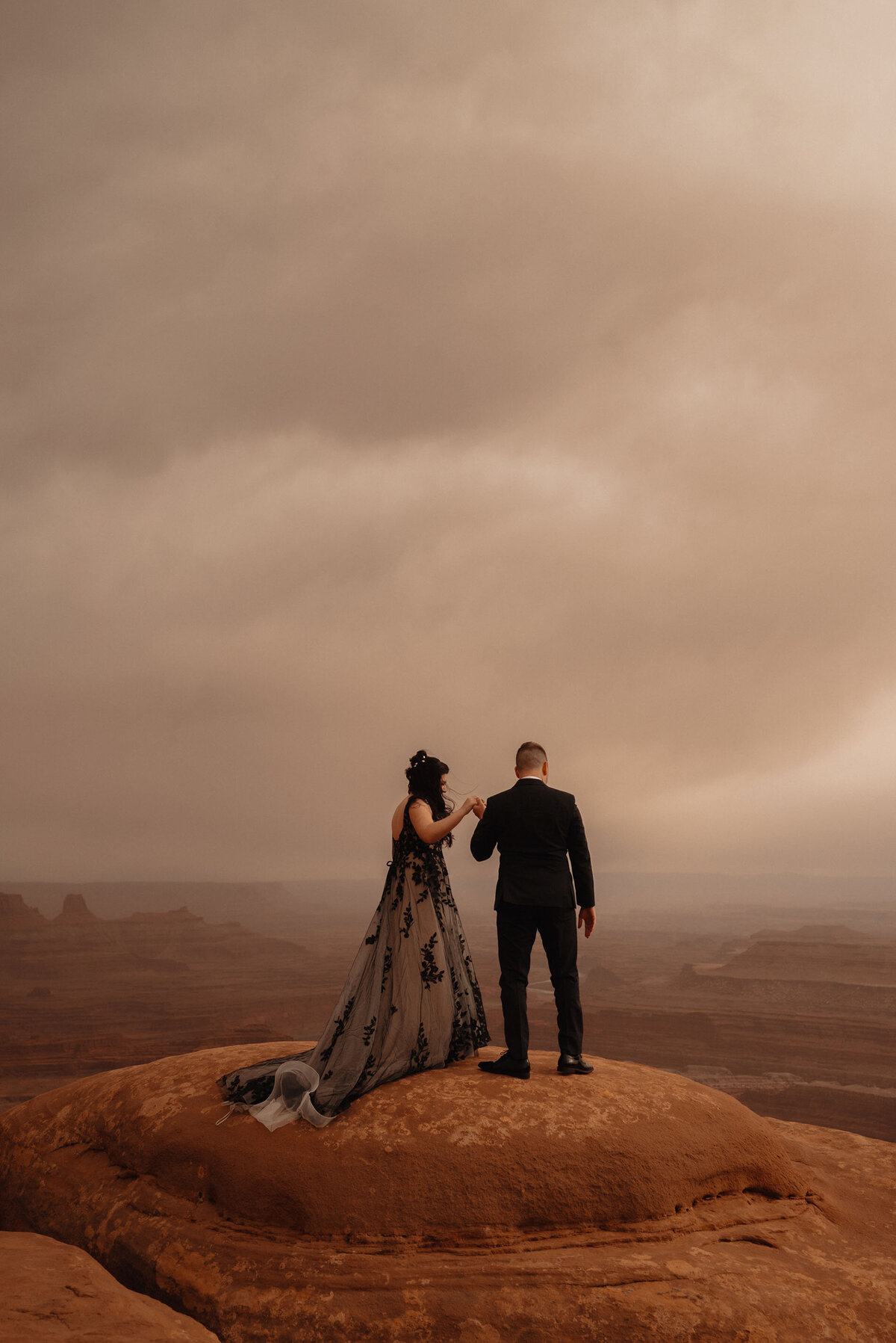 Dead Horse Point State Park elopement couple look out at beautiful scenery in Moab, Utah