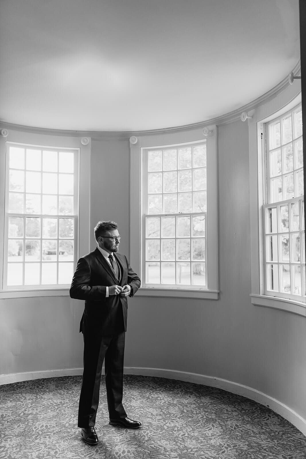 Groom buttoning suit