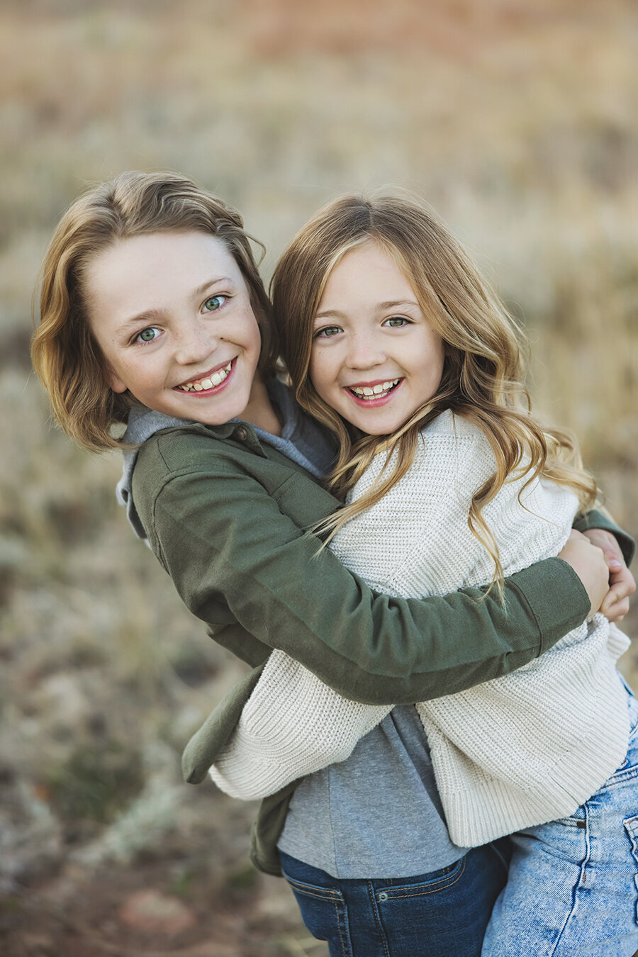 Siblings hugging each other on a fall night