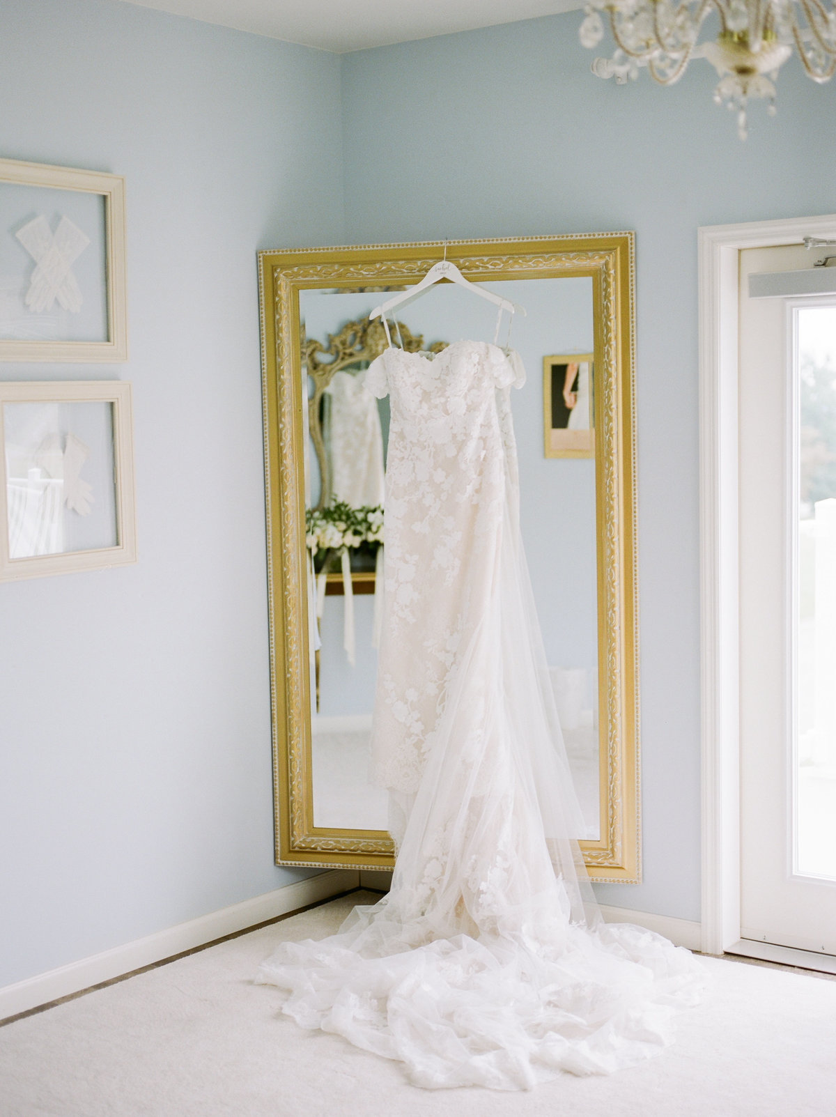 bridal gown hanging on mirror