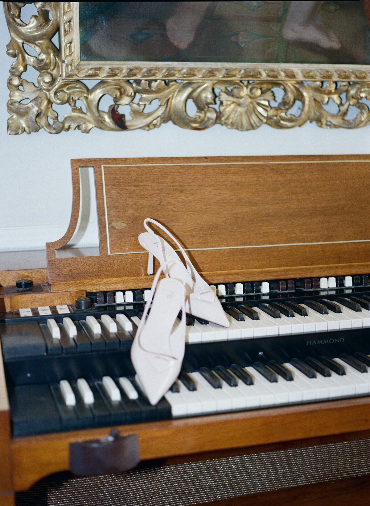 Prada shoes on a piano, photographed on film