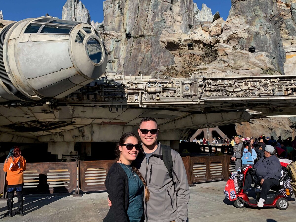 owner and husband posing at Disney Star Wars ship attraction