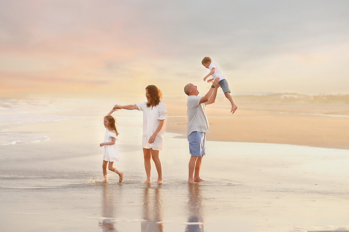 Parents play with their children during Family Photoshoot on Isle of Palms Beach. 