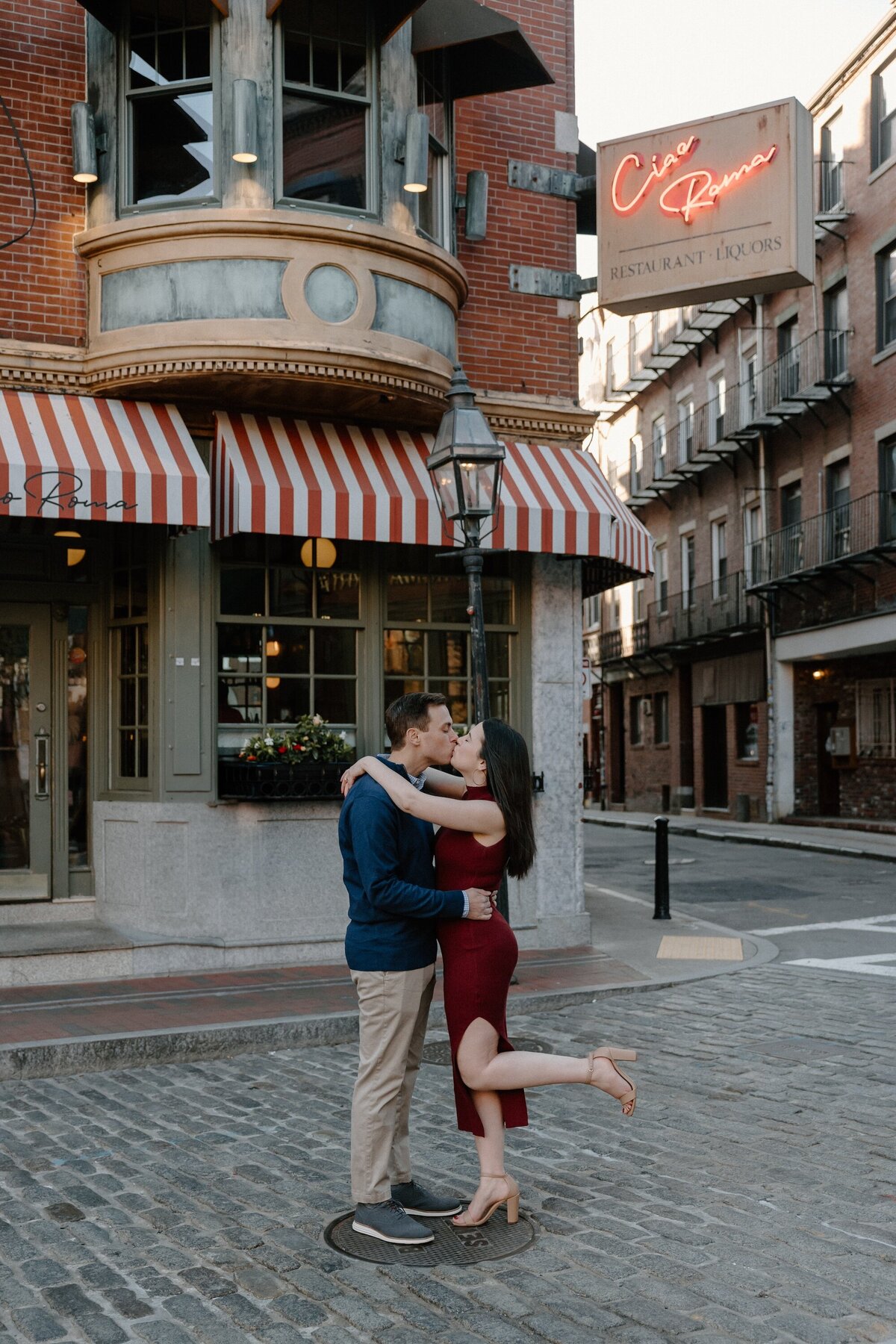 engaged couple kissing in north end boston
