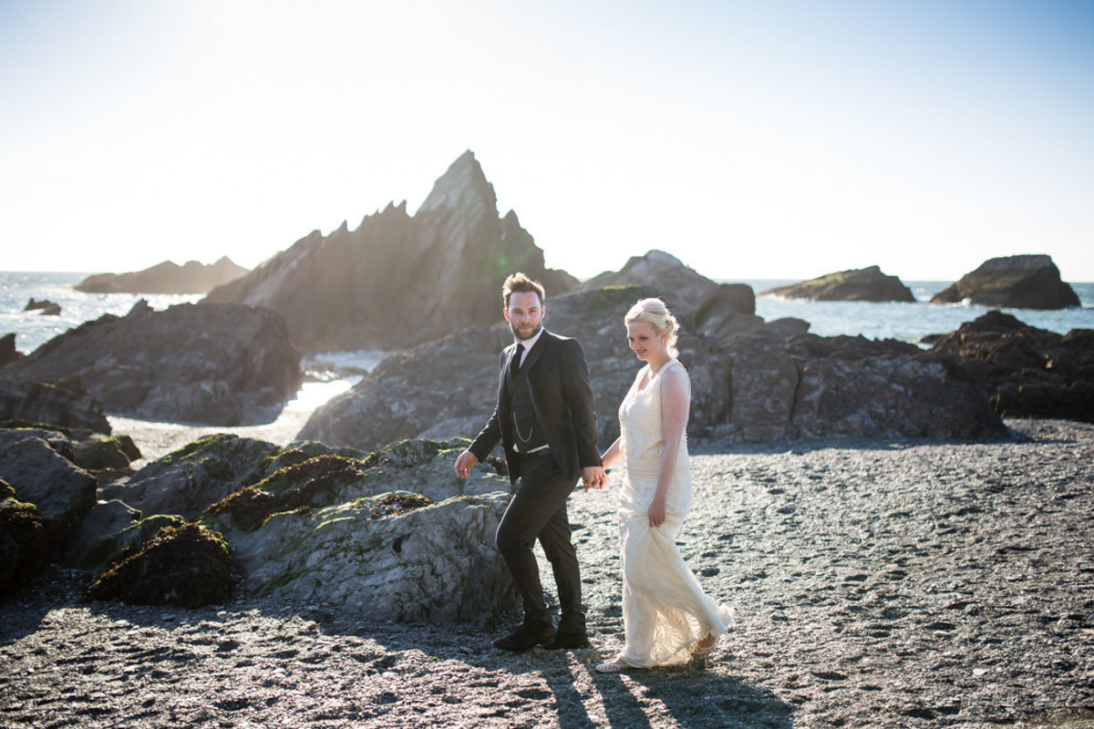 Wedding couple having a beach  stroll at Tunnels Beaches