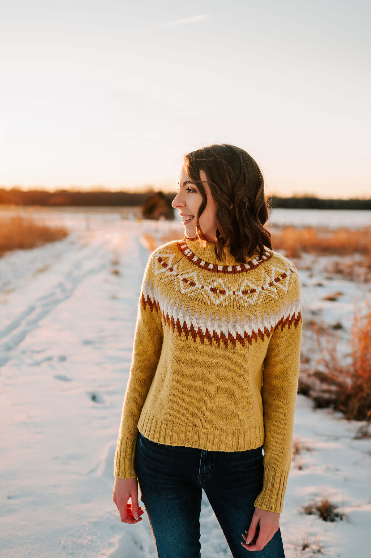 teen girl standing in snow during senior photography session in Branson Missouri