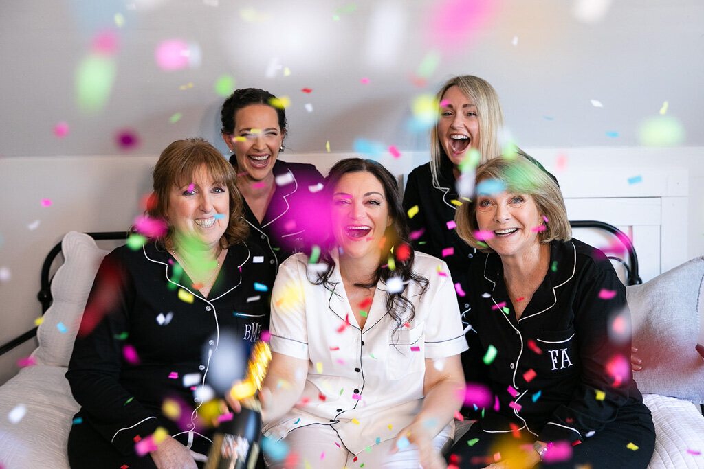 Bride and loved ones celebrate with confetti and comfy cozy PJs
