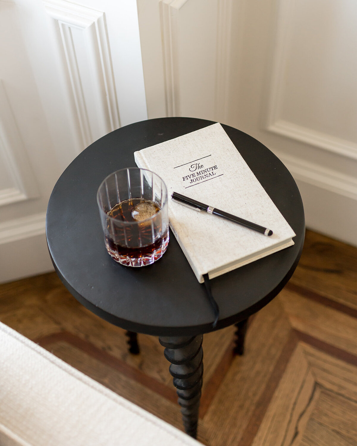 melinda chesson interiors boston black sidetable with journal and drink