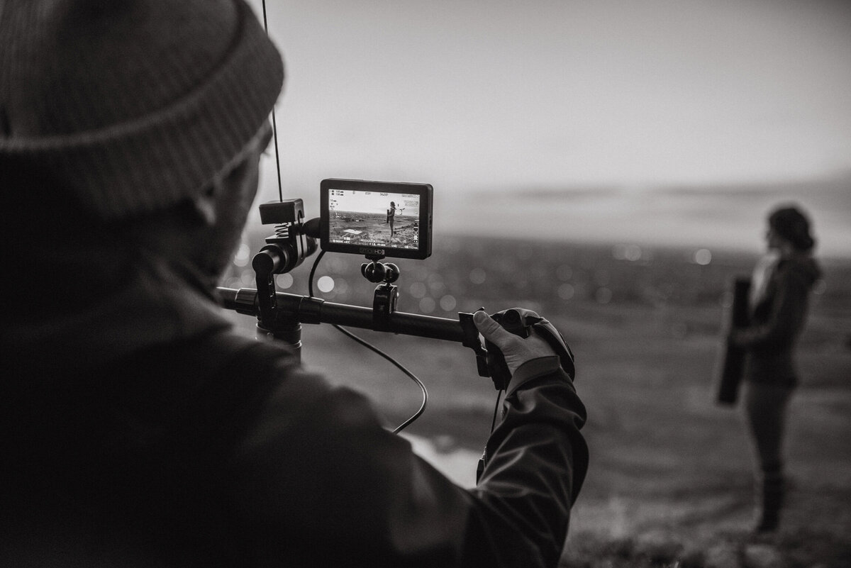 A black and white image of a Future Fox Media team member adjusting video equipment during a shoot. This photo captures the behind-the-scenes dedication and expertise that go into creating impactful video content in Denver, Colorado