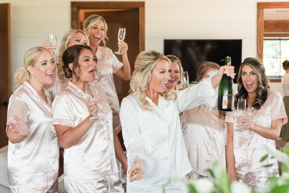 bride and bridesmaids popping champagne kent island resort