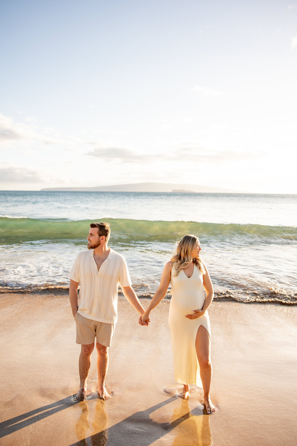 Maui Couples photographer captures couple holding hands during beach maternity photos