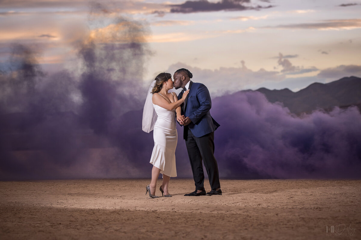 las vegas dry lake bed elopement, couple with smoke bomb, purple smoke, bride and groom, blue tuxedo