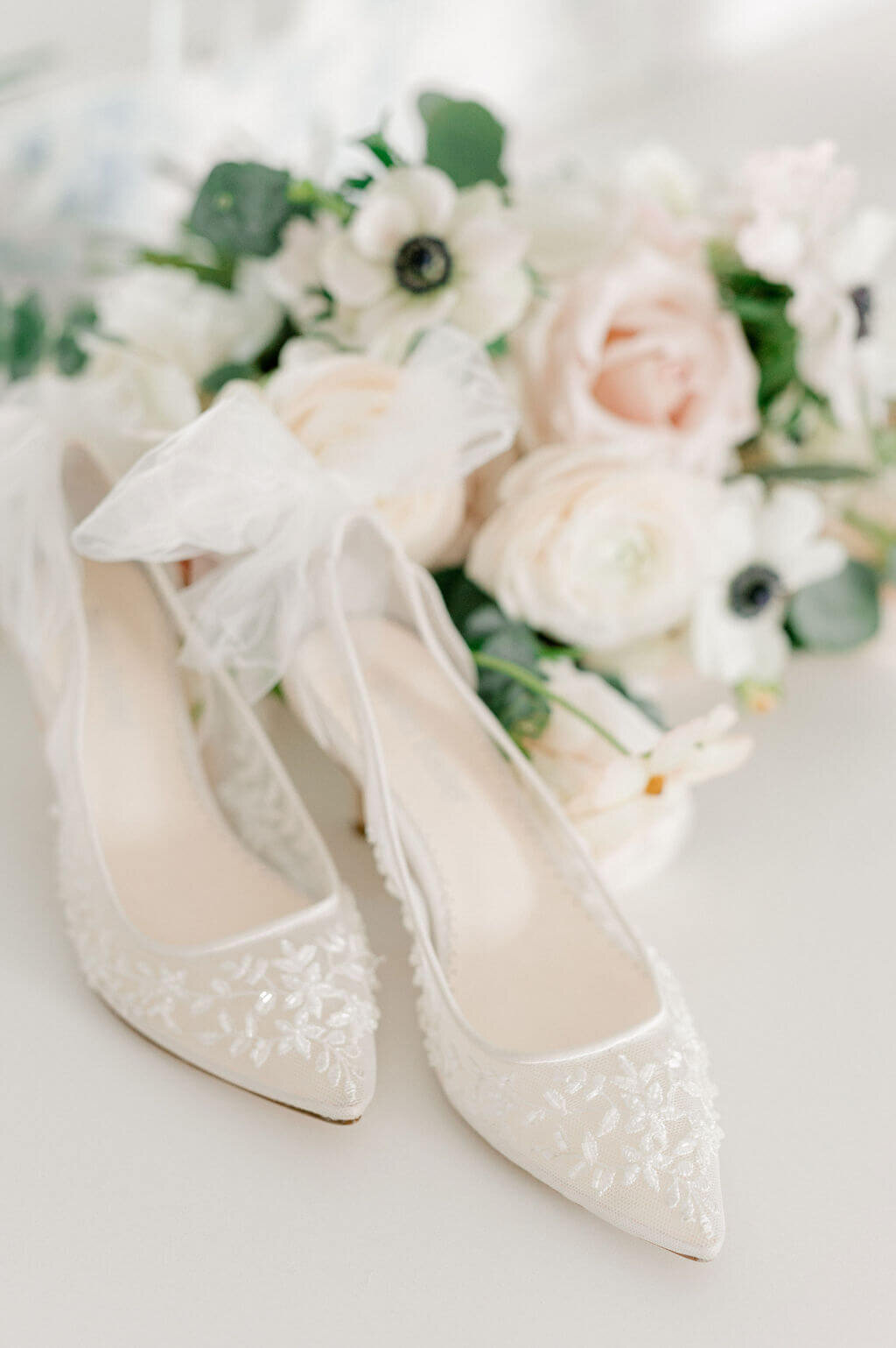 Bella Belle lace wedding shoes with blush bouquet for wedding photography portraits