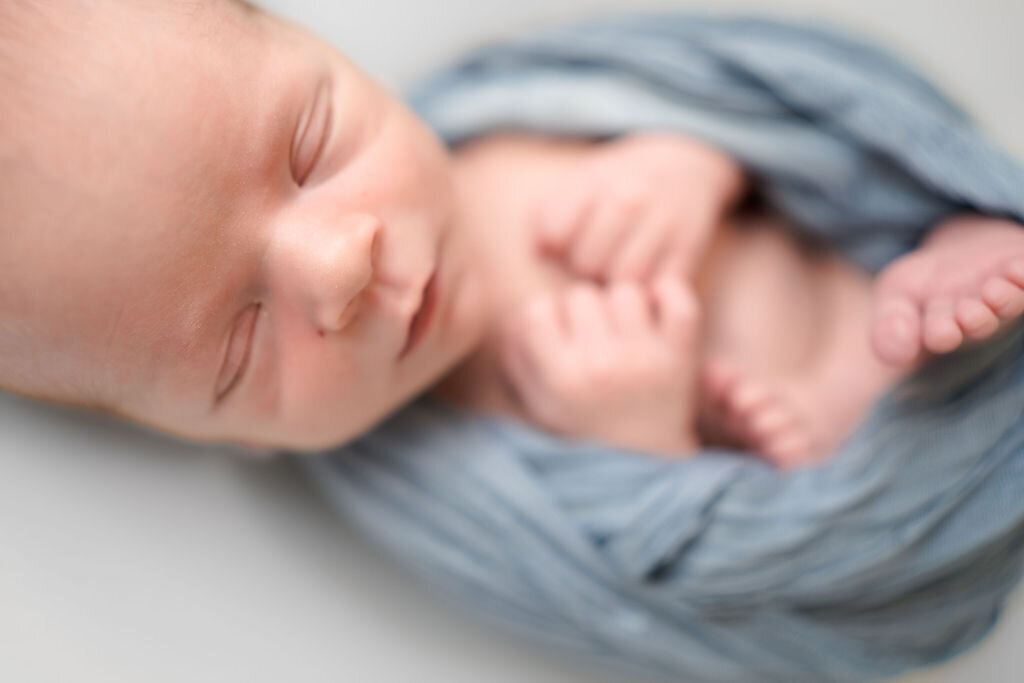 Thistle and bloom photography captures detail of baby boys sweet little nose during a newborn photography session.