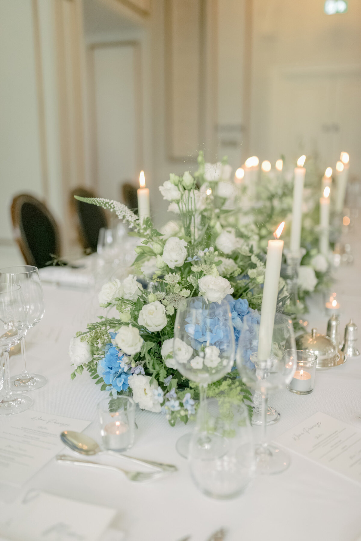 Wedding flowers and candles on table by Wild Burnett at Gleneagles on a black tie wedding day. Image by luxury fine art wedding photographer, Jill Cherry Porter.