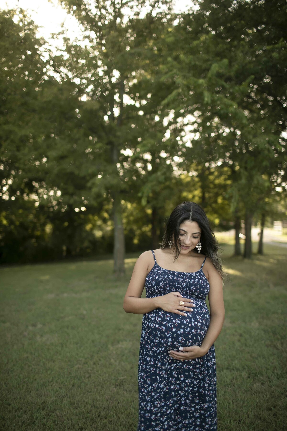 Expectant mom snuggling with her baby belly at her maternity shoot with Chunky Monkey Photography