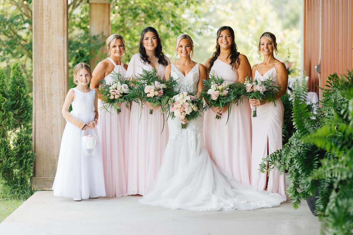bride standing with her bridal party on her wedding day