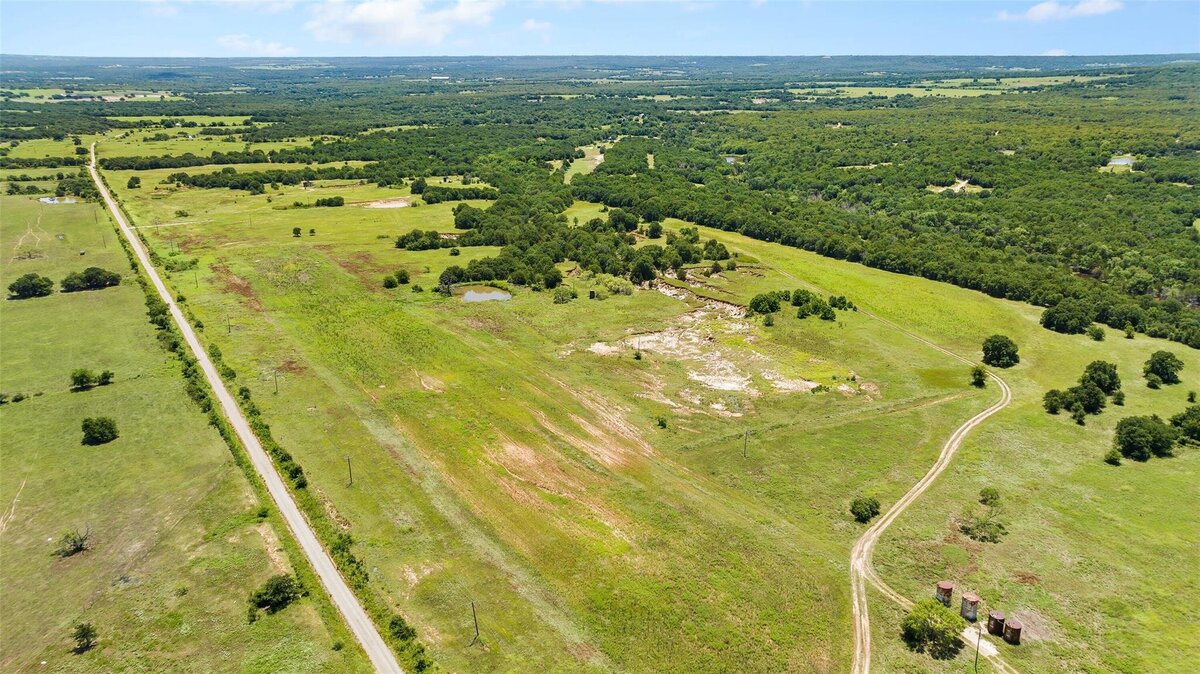 Aerial view of 55-acre property with mature post oaks in Saint Jo, TX