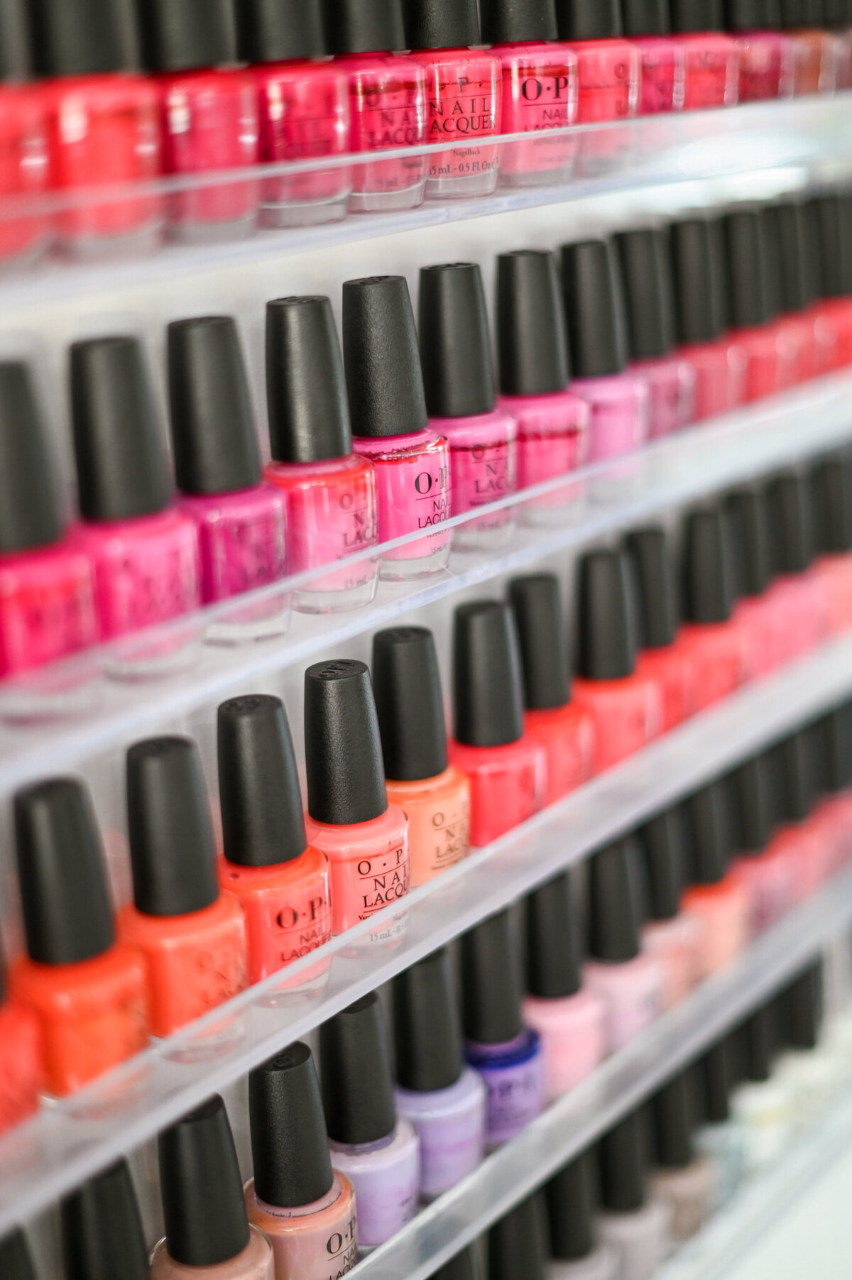 A pop of color! A neatly organized selection of OPI nail polish adds energy and personality to the salon.