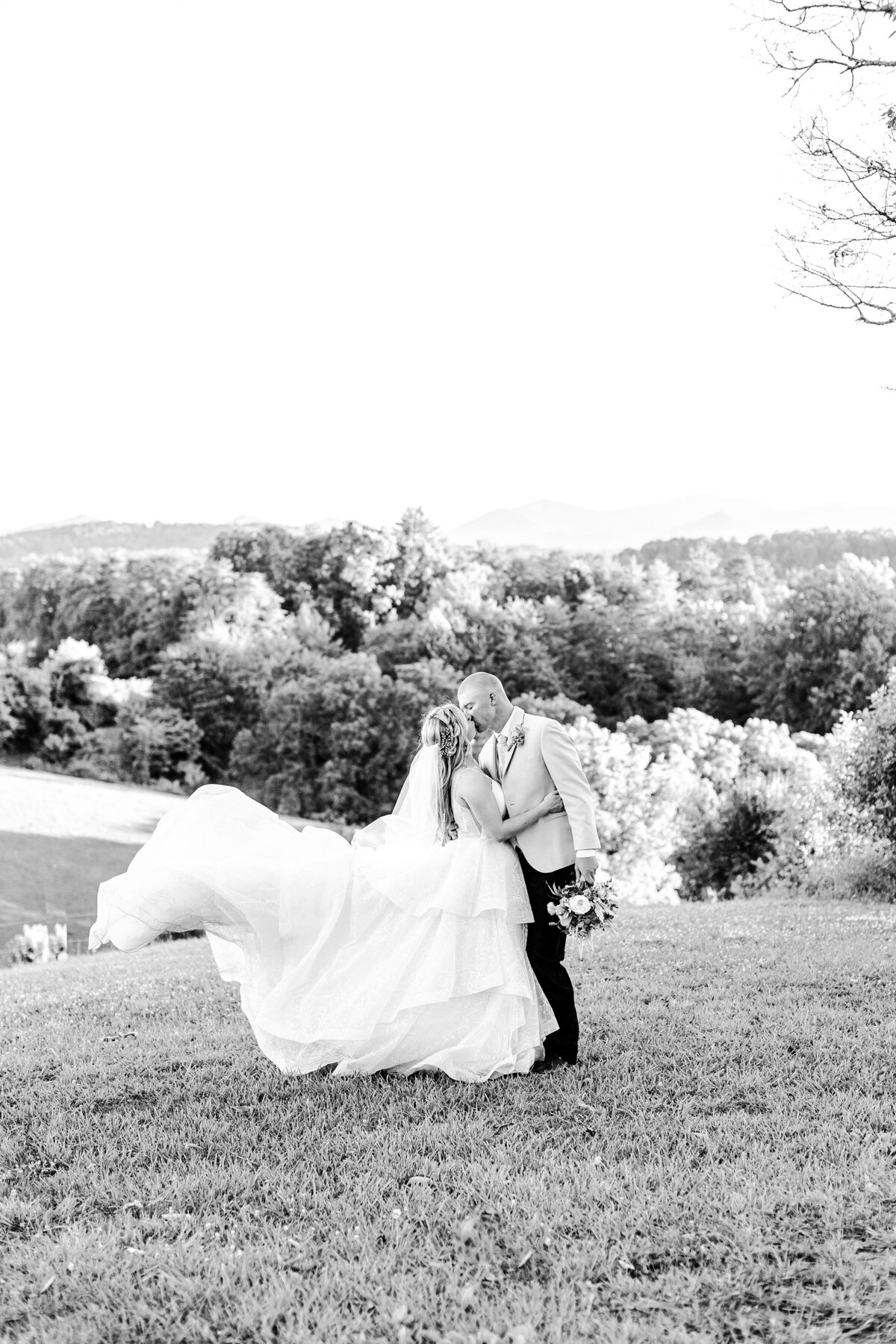 black and white photo of bride and groom with mountain views