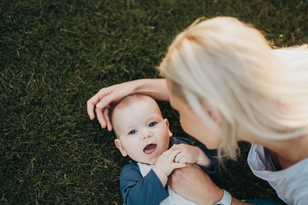 mom-and-son-tender-moment-on-grass