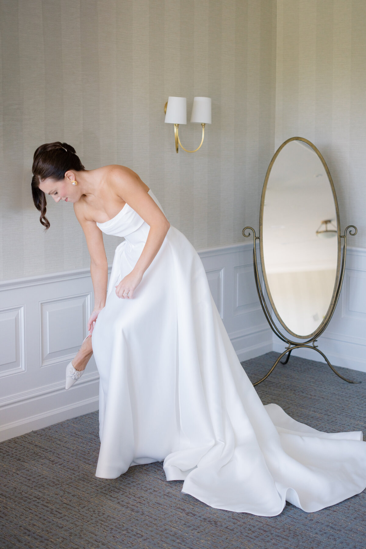 bride getting dressed at Mission Hills Country Club Kansas City wedding
