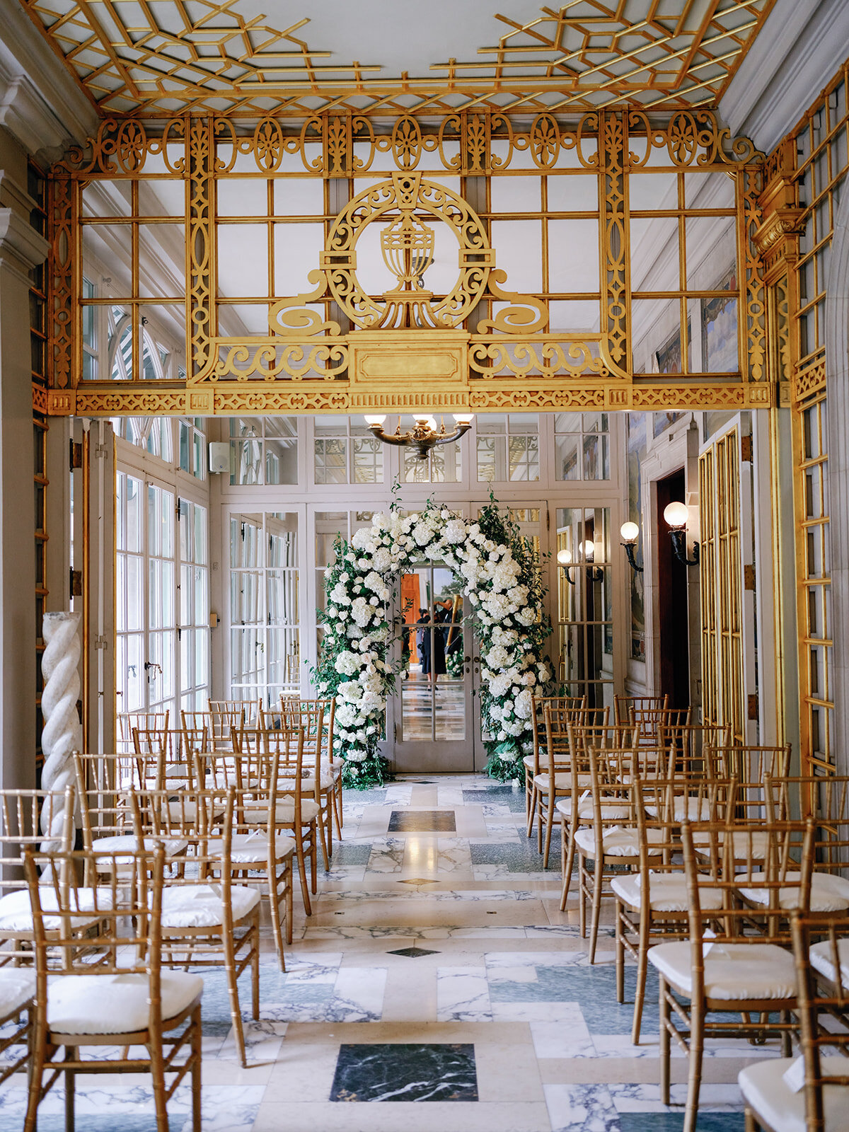 Ceremony location with a floral arch at Anderson House