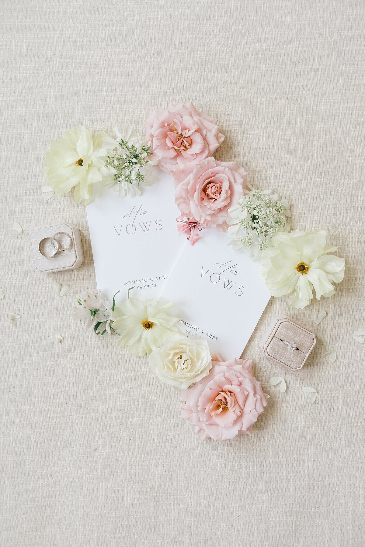Columbus wedding  photographer captures flat lay photo of two vow books surrounded by white and pink florals