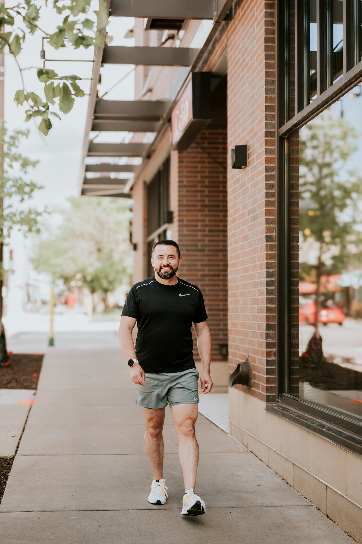 Athletic dating portrait of a man posing mid-stride on a Minneapolis path, captured for a dynamic and engaging online dating profile.