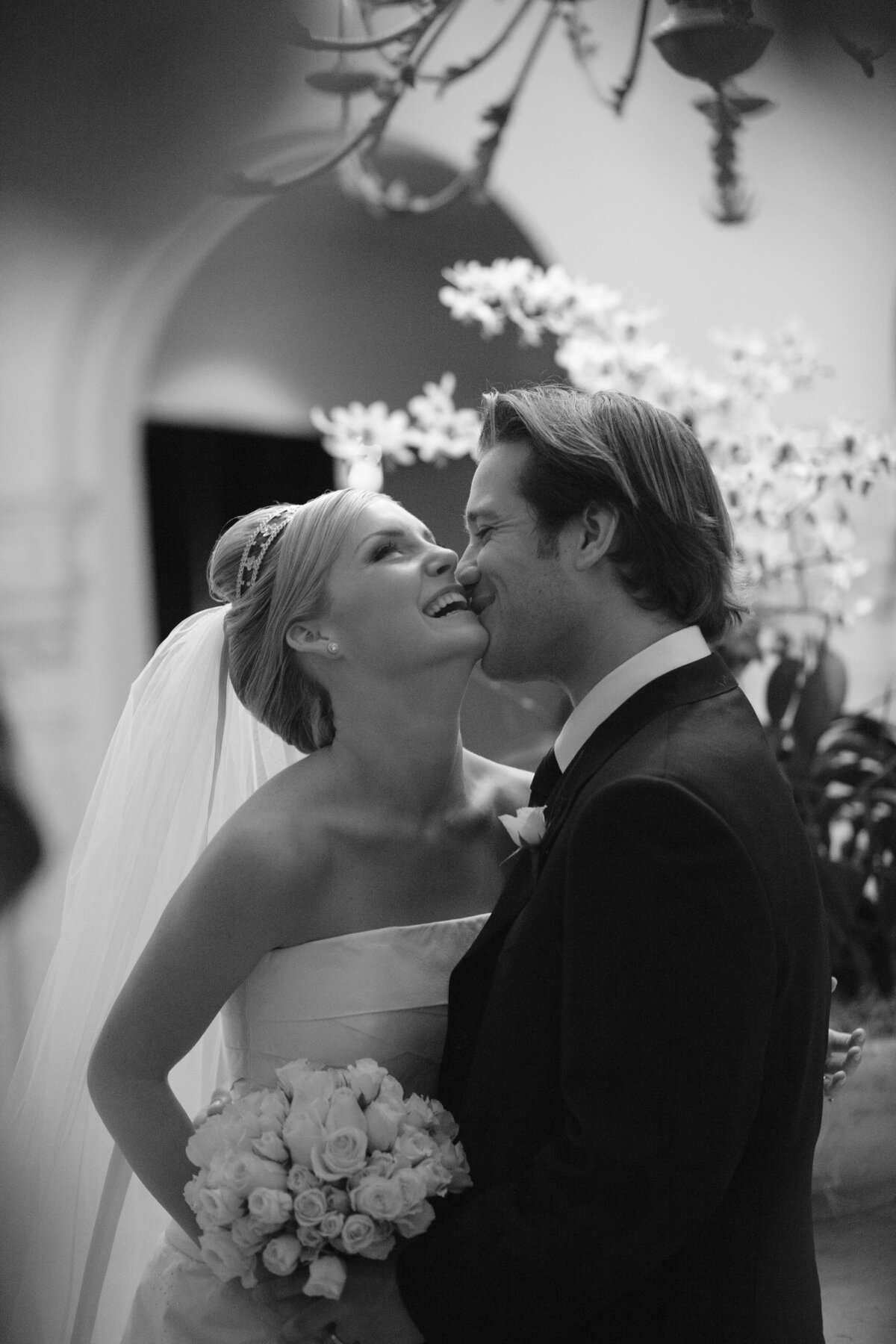 Intimate black and white moment of a Miami bride and groom sharing a laugh.