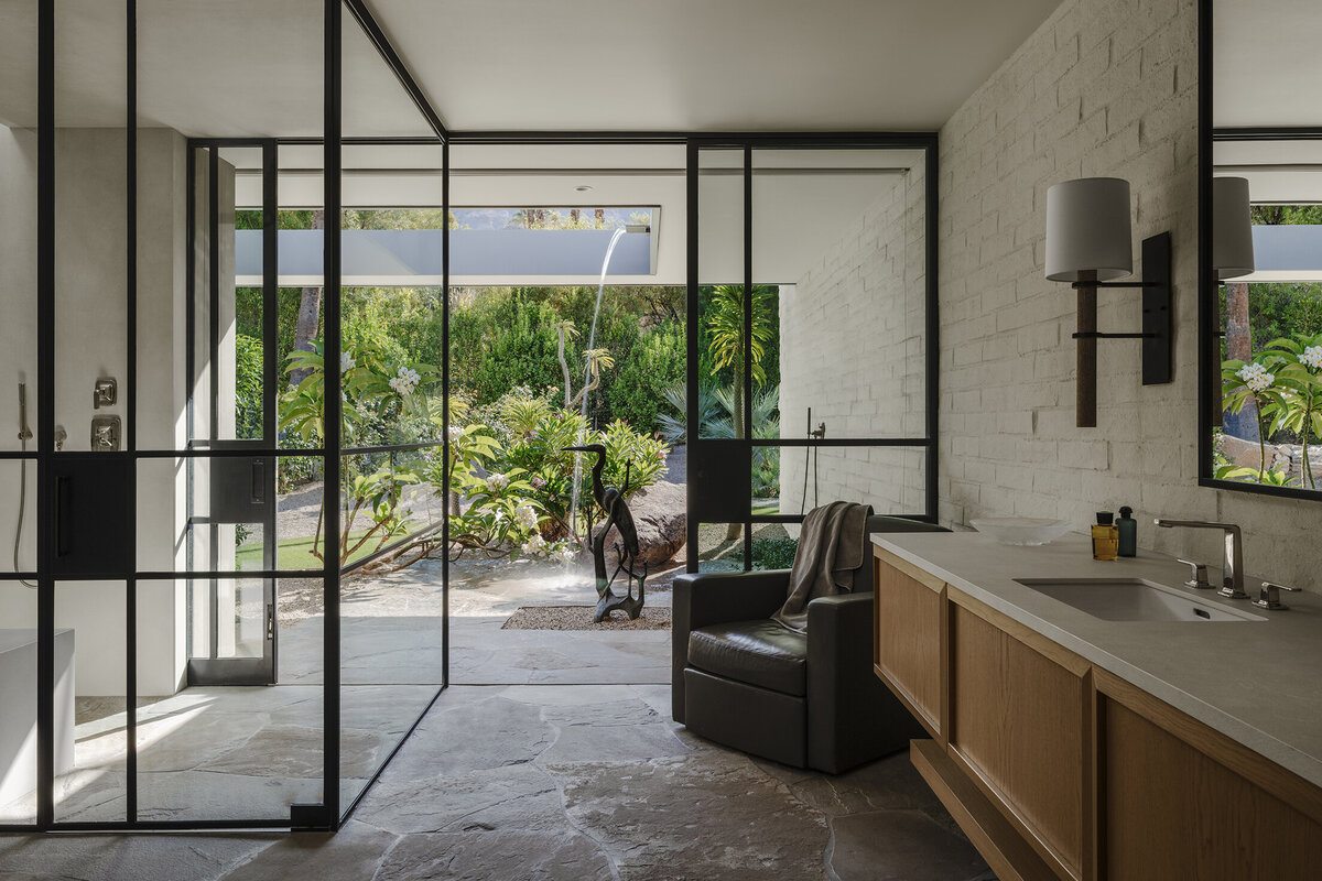 Master bedroom entrance with artwork with metail backdrop on a board formed concrete wall designed by Palm Springs architect, Sean Lockyer.