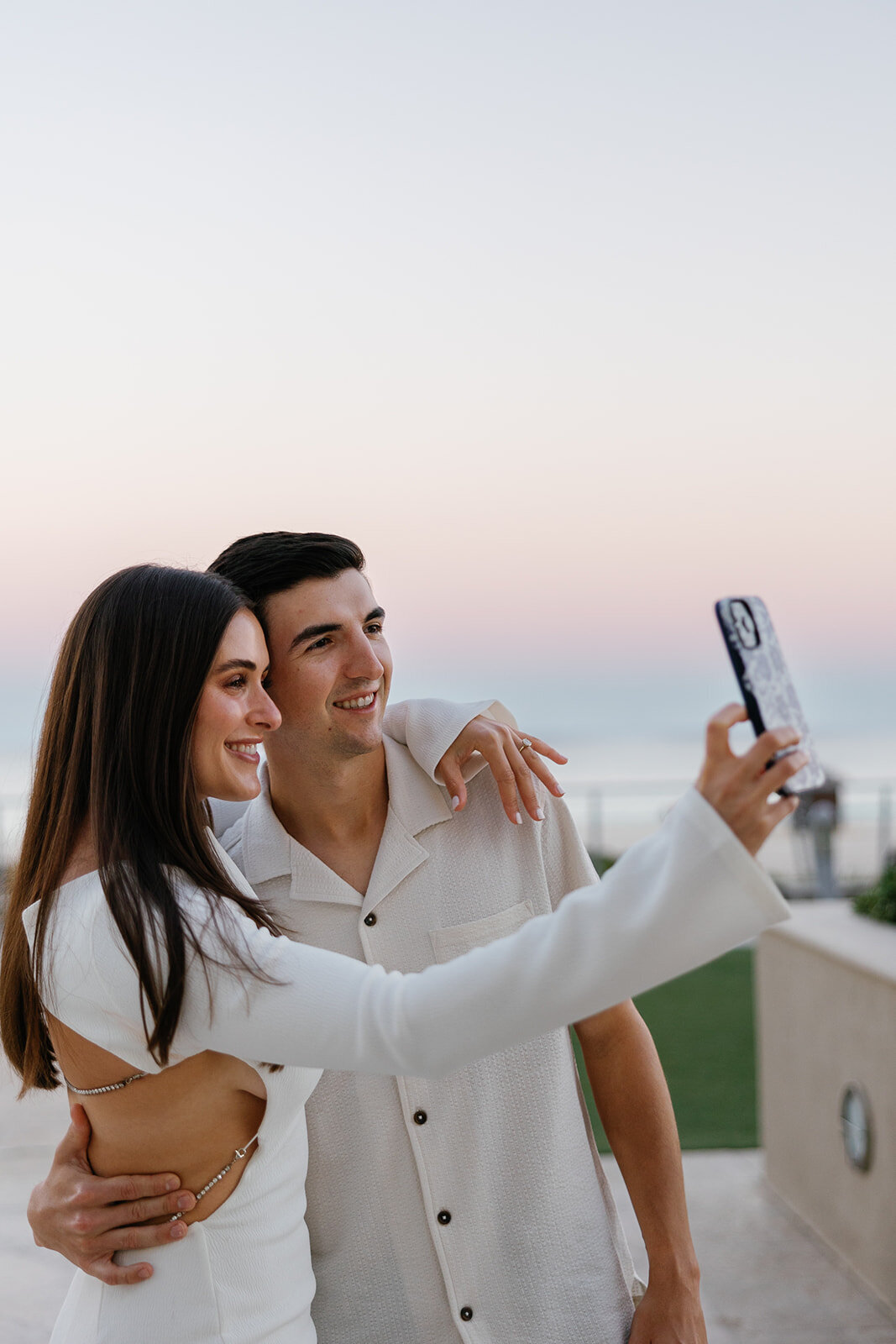 Rebecca and Graysen snap a romantic selfie, capturing the joy of their engagement session at Marriott Hotel Fort Lauderdale, a cherished memory from their Florida Keys love story.