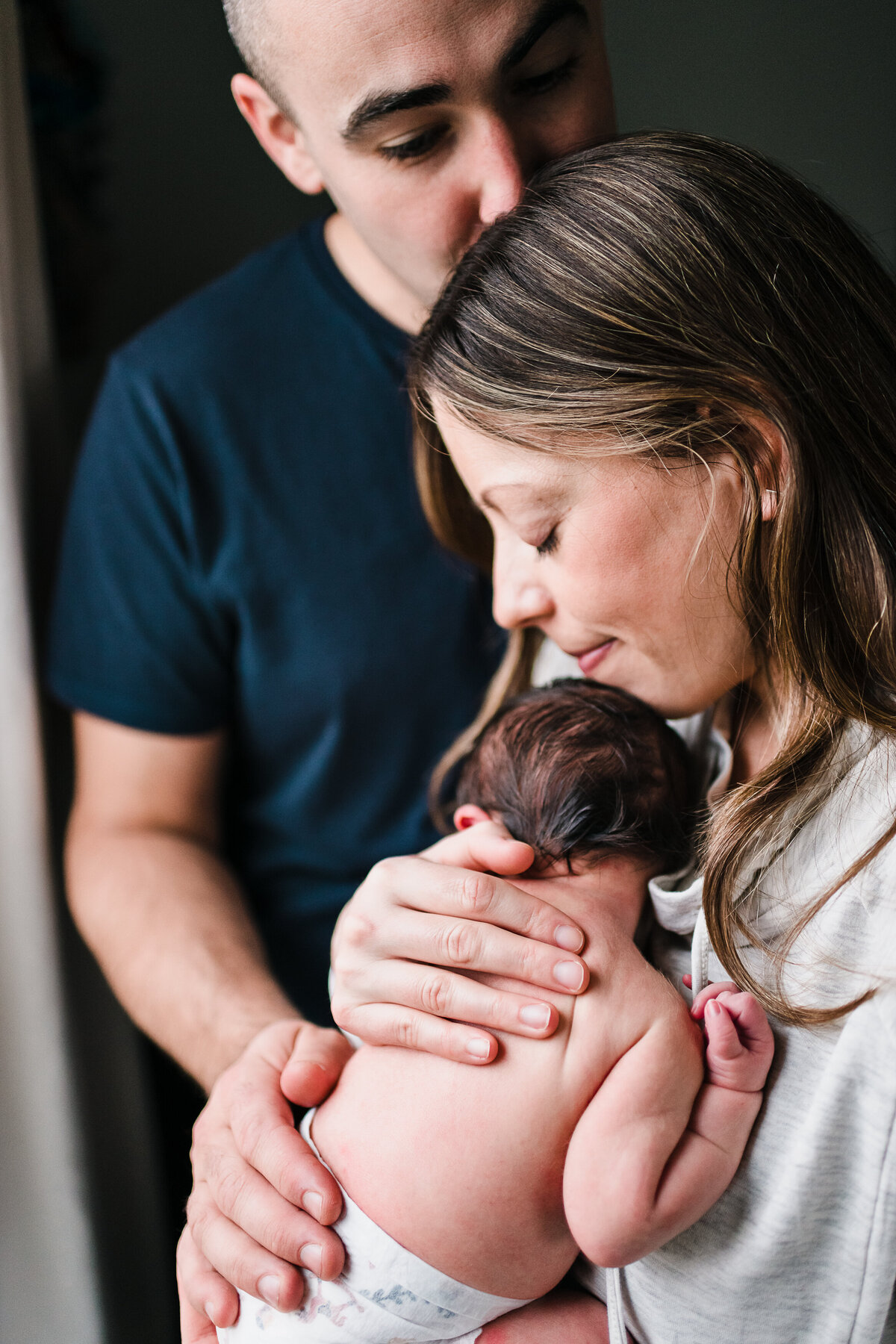mother father portrait with new baby