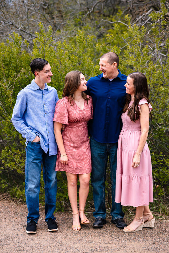 A family looks and smiles at each other.