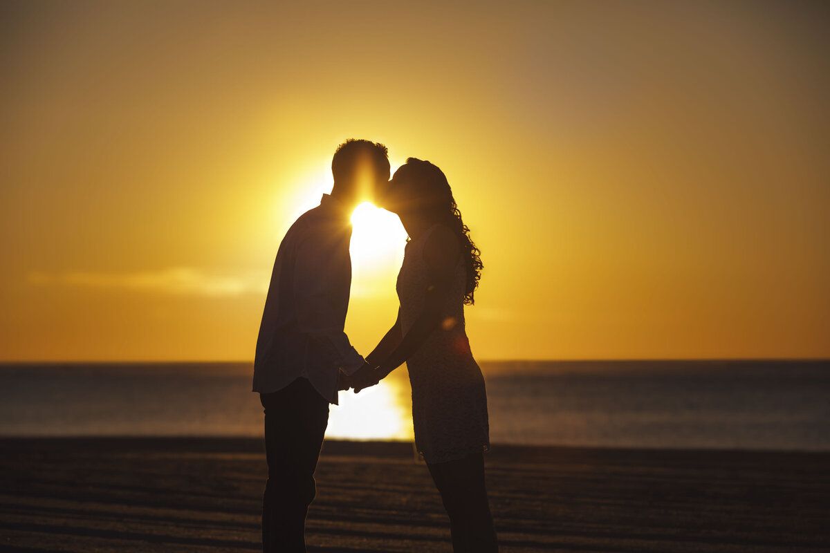 Couple in silhouette during sunrise engagement photo in Manasquan New Jersey