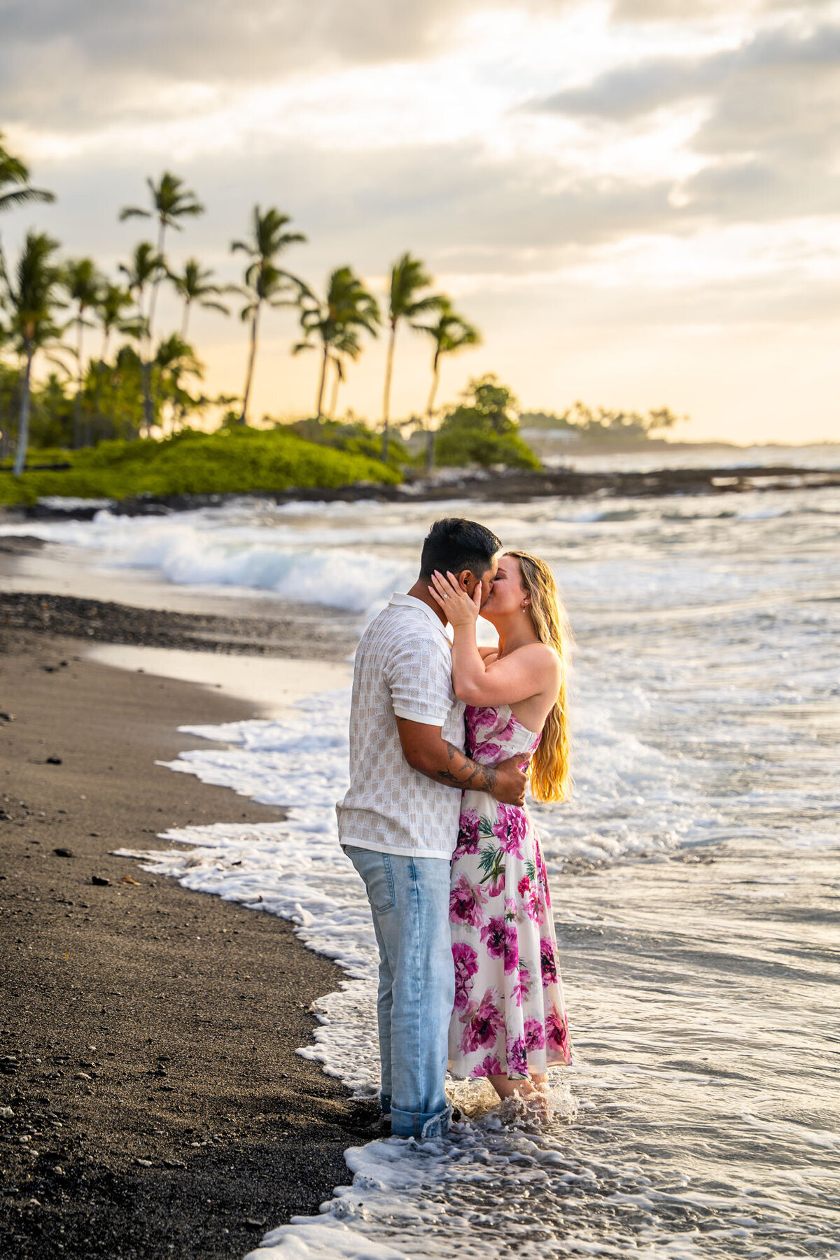 Hawaii engagement photography of couple kissing on the beach, taken by Hawaii Adventure Portraits