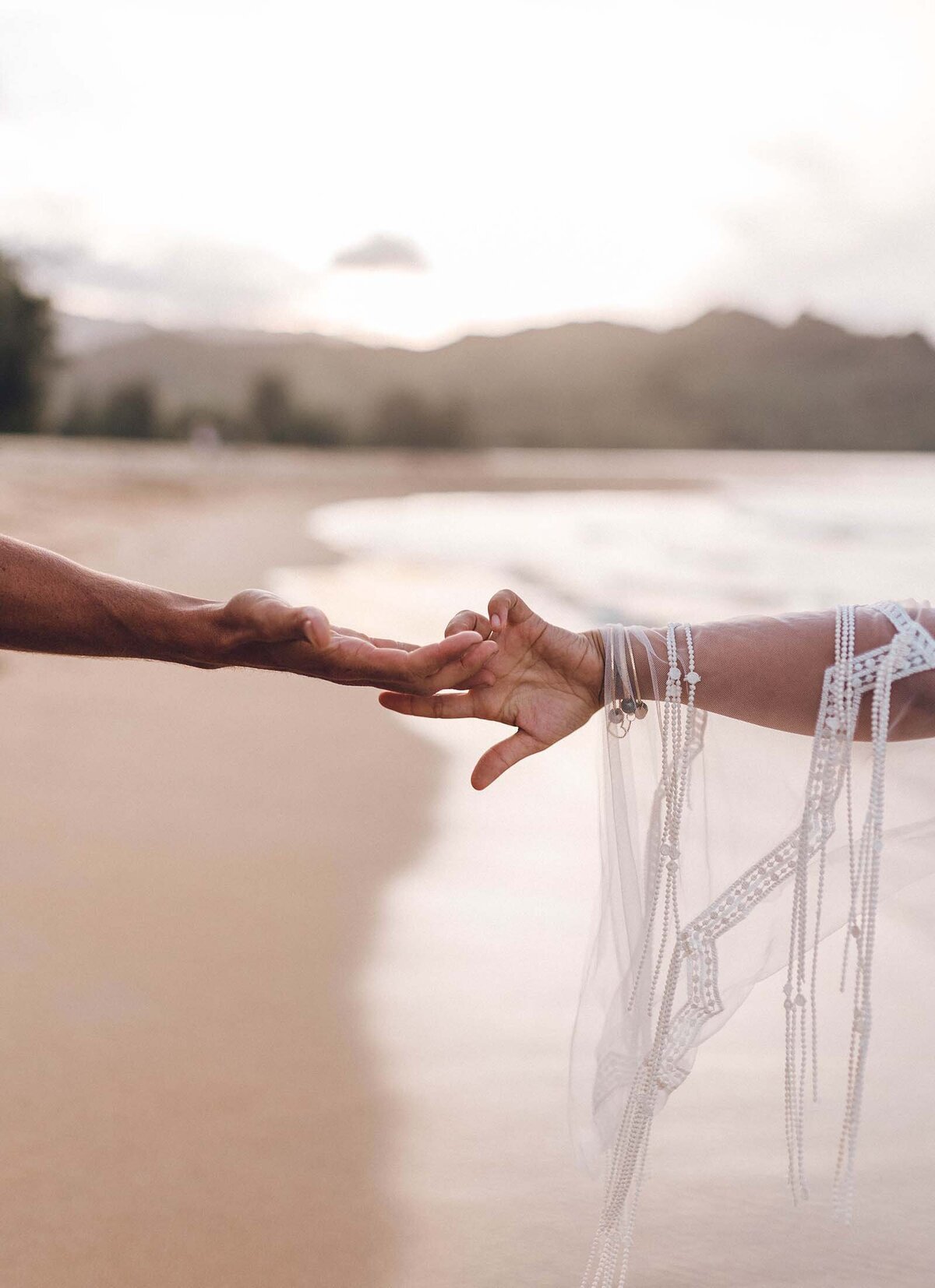 Hands holding on the beach