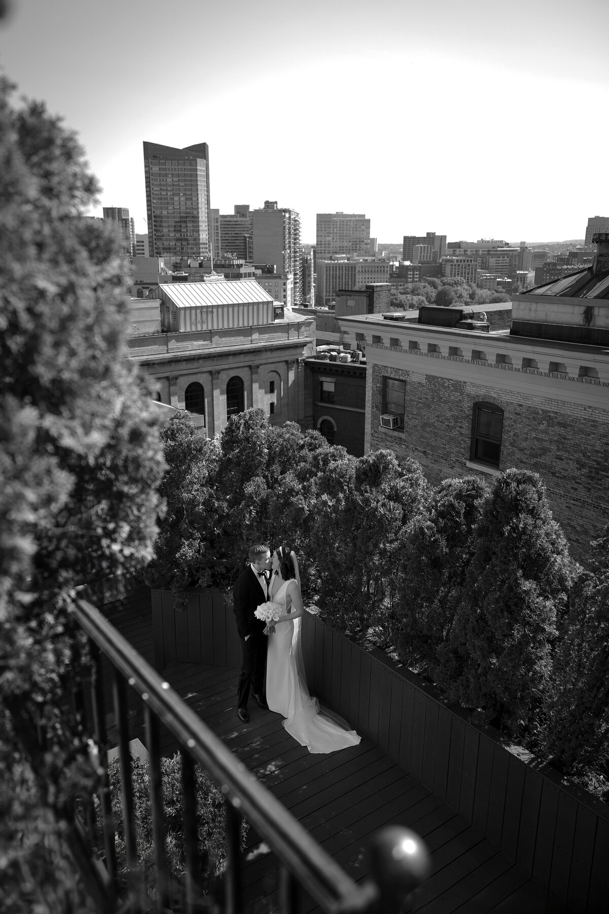 Bride and Groom embrace on a rooftop in Boston.