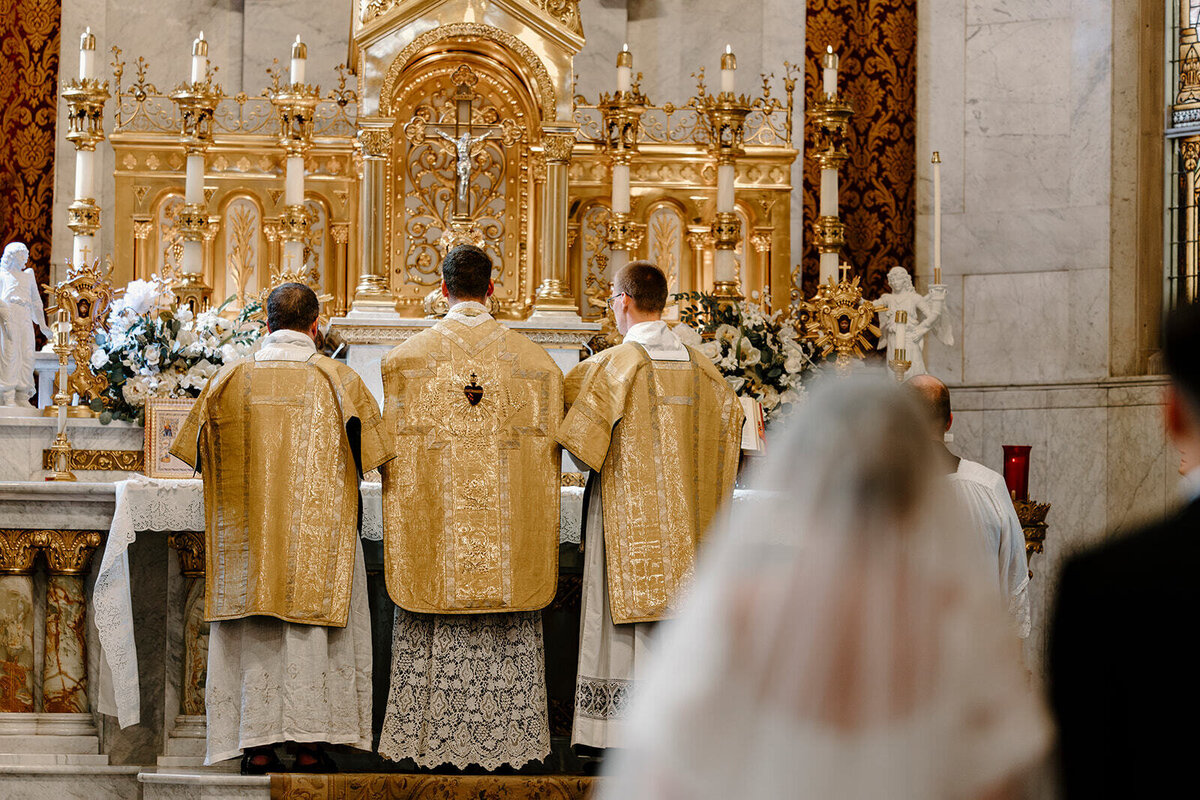 preparing for the consecration at a Catholic wedding