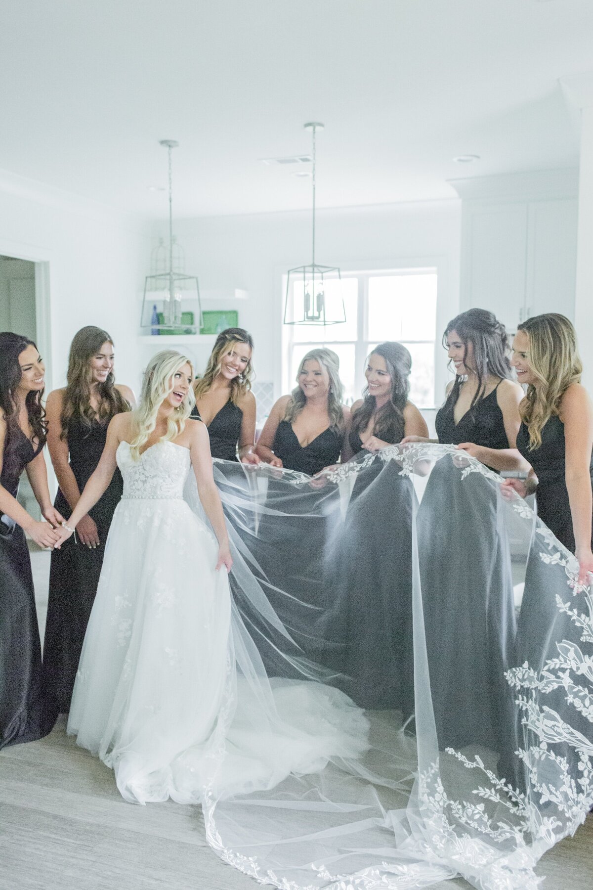 bridesmaids helping bride with her dress