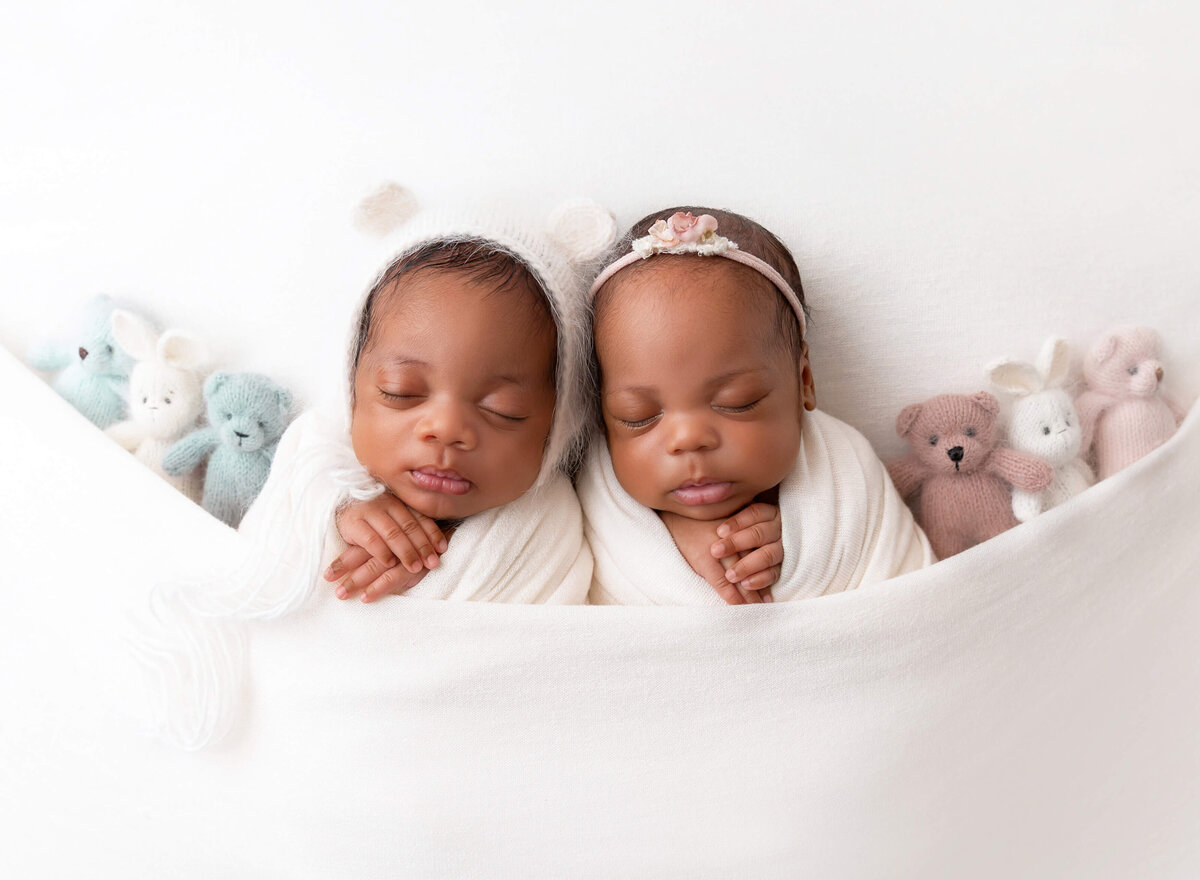 Twin newborn photo captured by NYC newborn photographer in Brooklyn studio — swaddled babies posed side by side