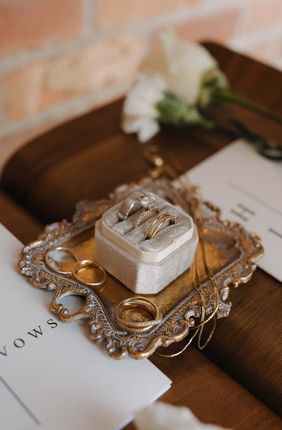 Wedding rings in a ring holder on a brass plate