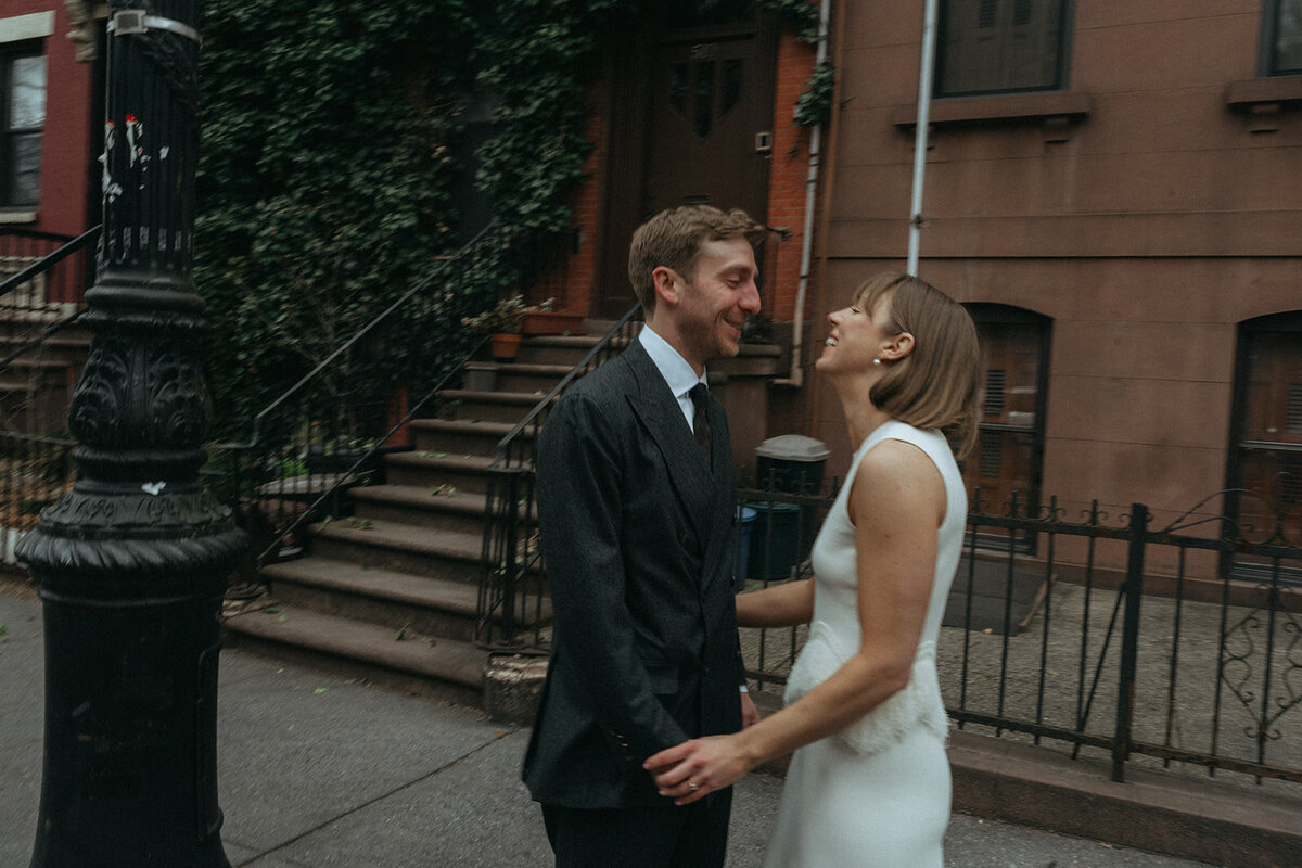 couple in front of brownstone during their elopement shot by Elsie Goodman Photography | NYC Elopement Packages