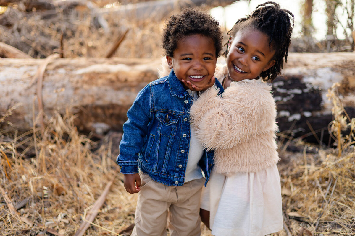 Siblings hugging and smiling together outdoors Bay Area Family Portfolio – Ellobelle Photograph