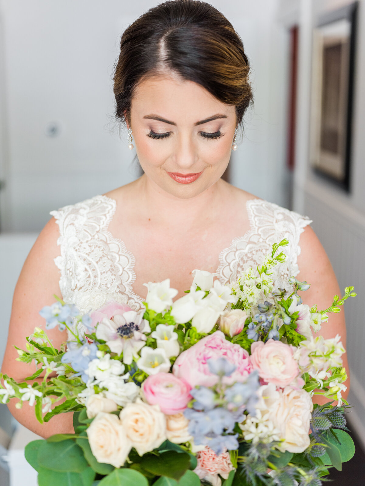 Bride looking down at her wedding bouquet