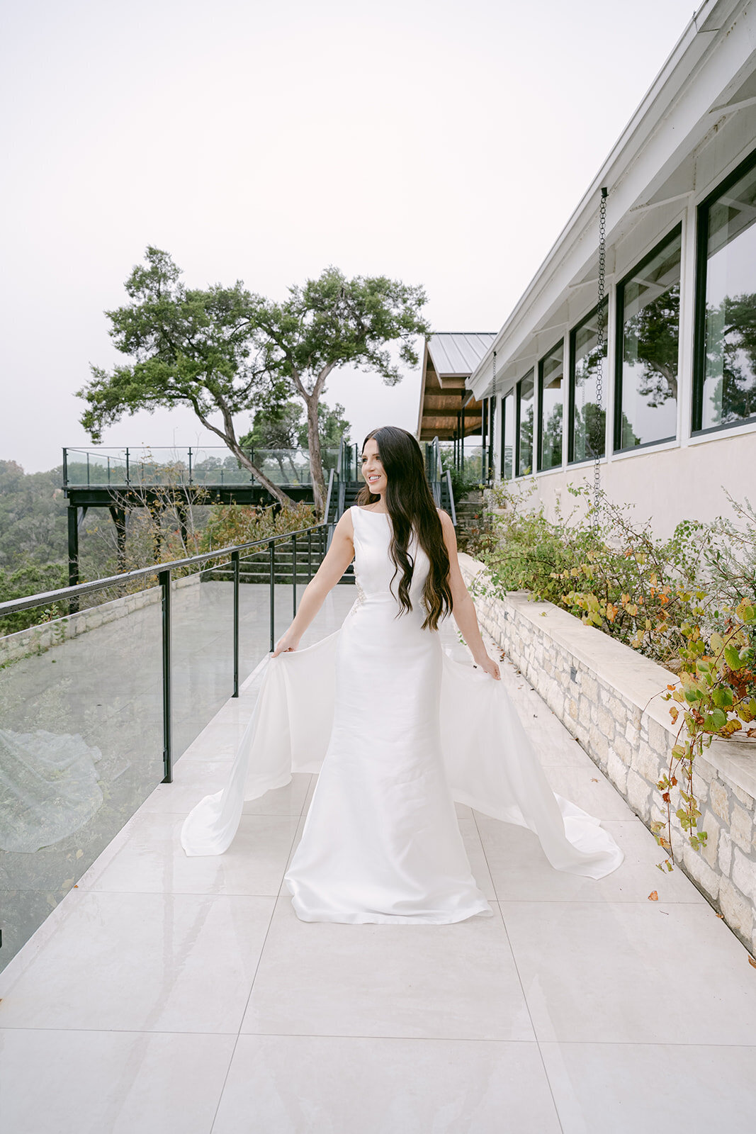 Bride captured outdoors non grand walkway, and modern architecture at The Videre Estate in Austin, TX.