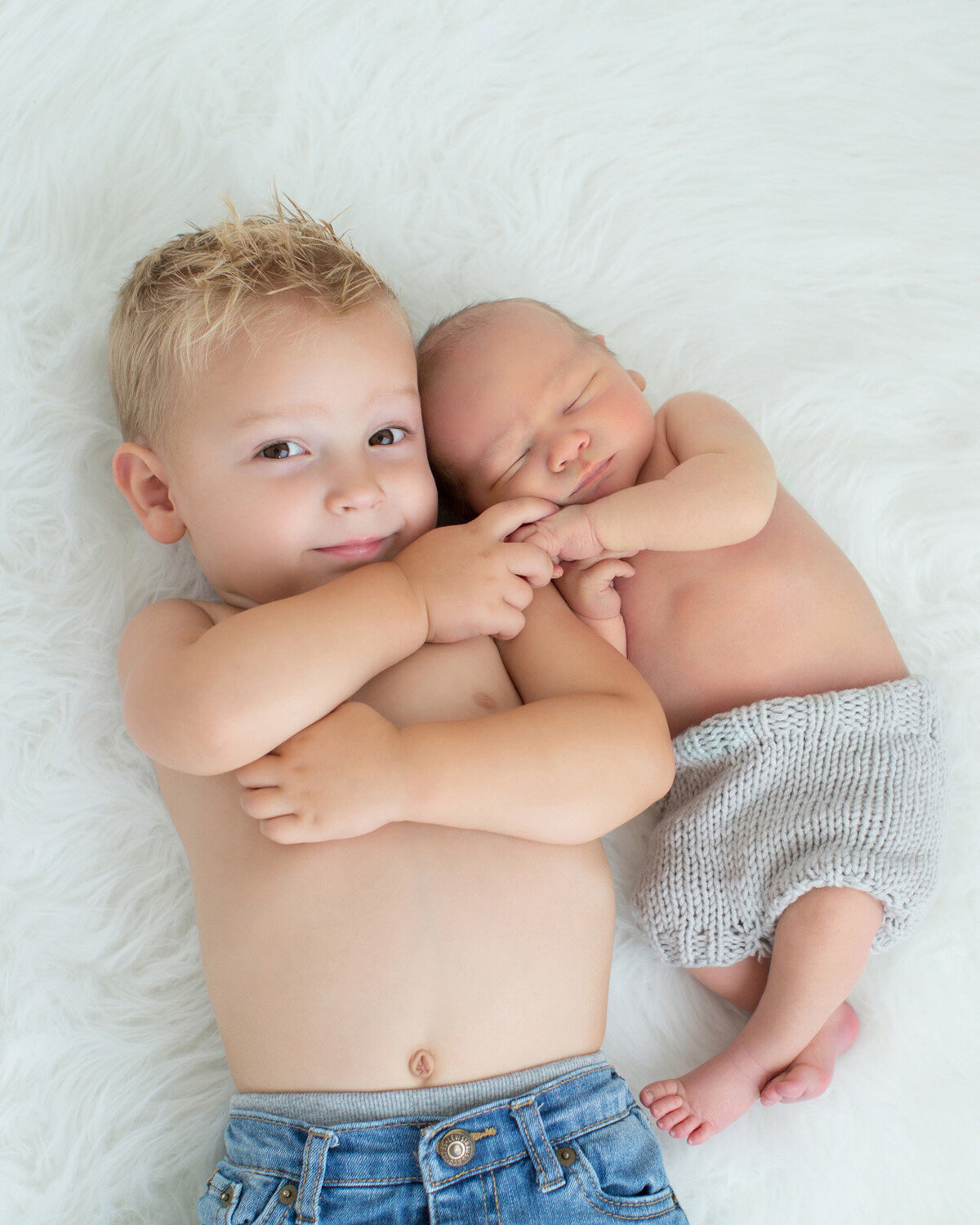 big-brother-holding-newborn-hand