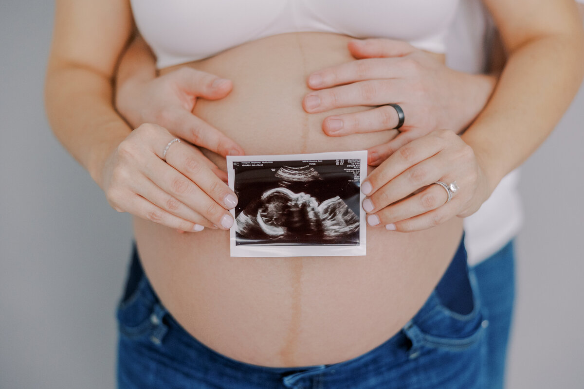 richmond-maternity-photographer-expecting-mother-holding-belly.jpg​