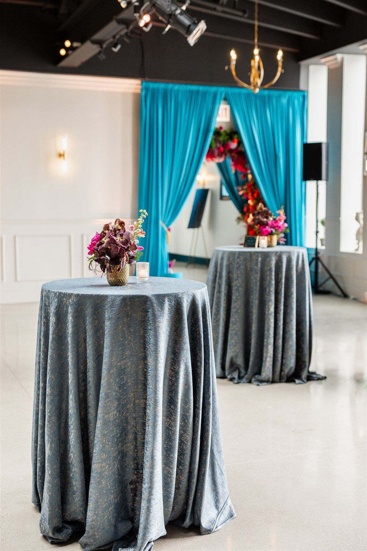 Event space styled with a Baroque theme, featuring ornate gold accents, rich fabrics, grand chandeliers, and intricate moldings, creating a luxurious and dramatic atmosphere